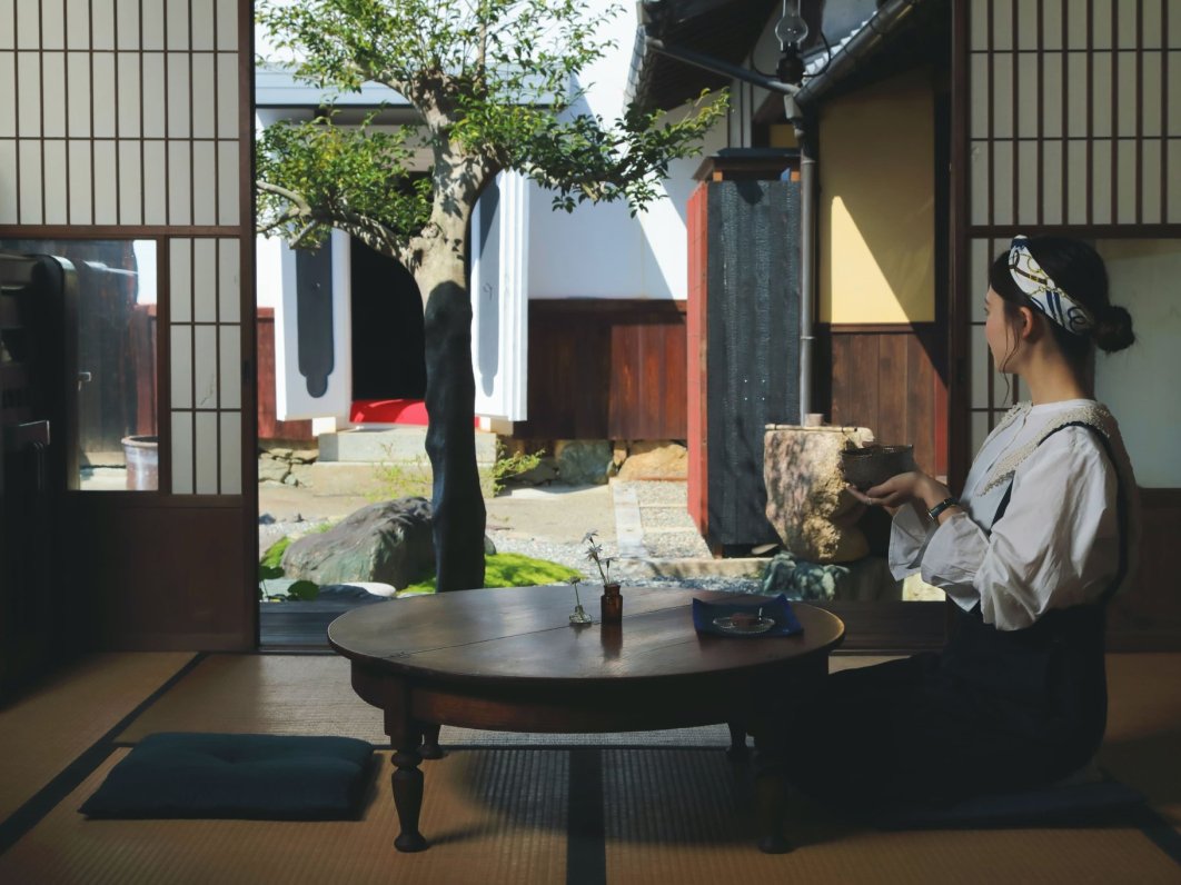 Sipping tea by an open shoji door